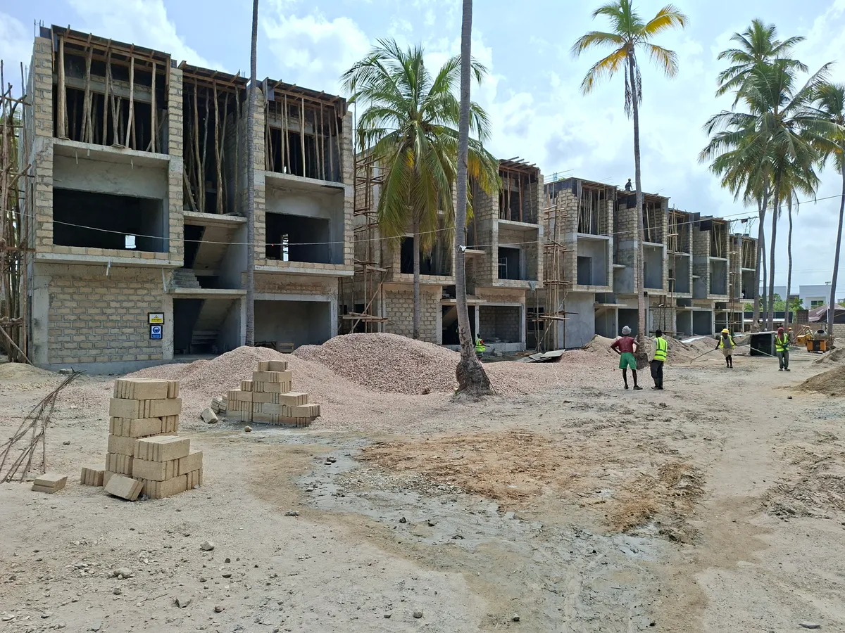 Multi-story residential construction site with workers in Zanzibar